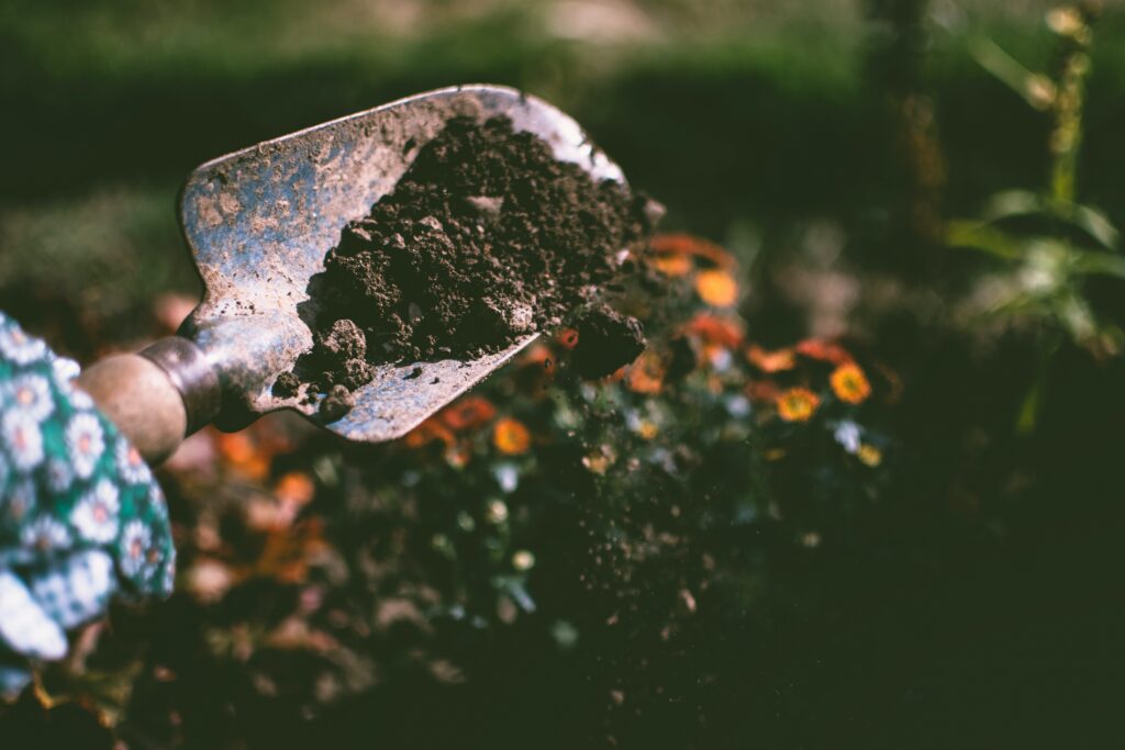 shovel in soil for putting all those gardening tips and tricks to use